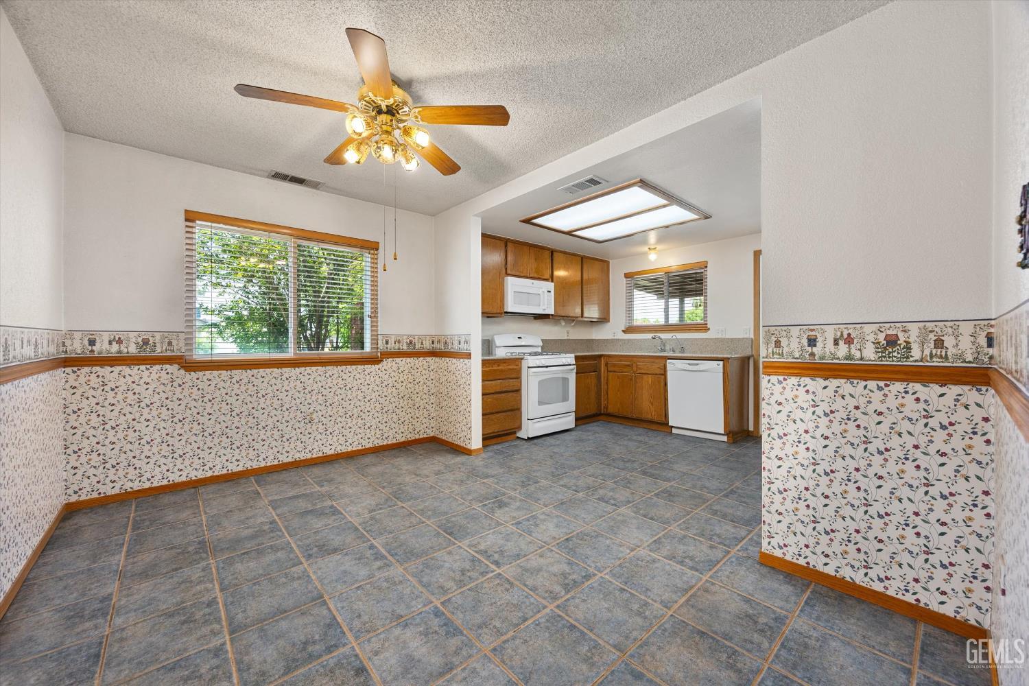 Undisclosed Address Bakersfield, CA 93307 - Photo 6 of 26 an empty room with windows and ceiling fan
