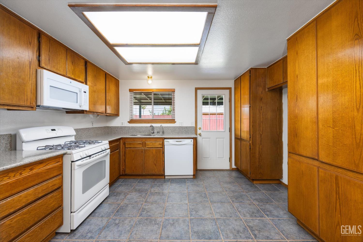 Undisclosed Address Bakersfield, CA 93307 - Photo 8 of 26 a kitchen with a refrigerator sink and stove