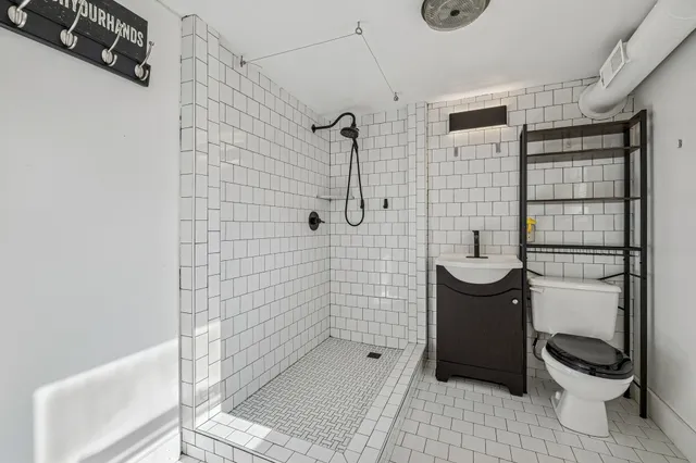 a bathroom with a toilet and a shower