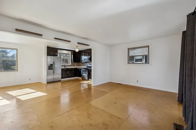 a view of kitchen with furniture and a refrigerator