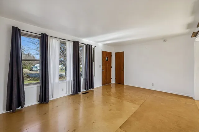 a view of an empty room with glass door