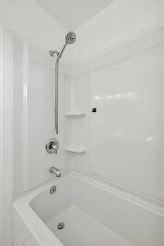 a bathroom with a bathtub and shower