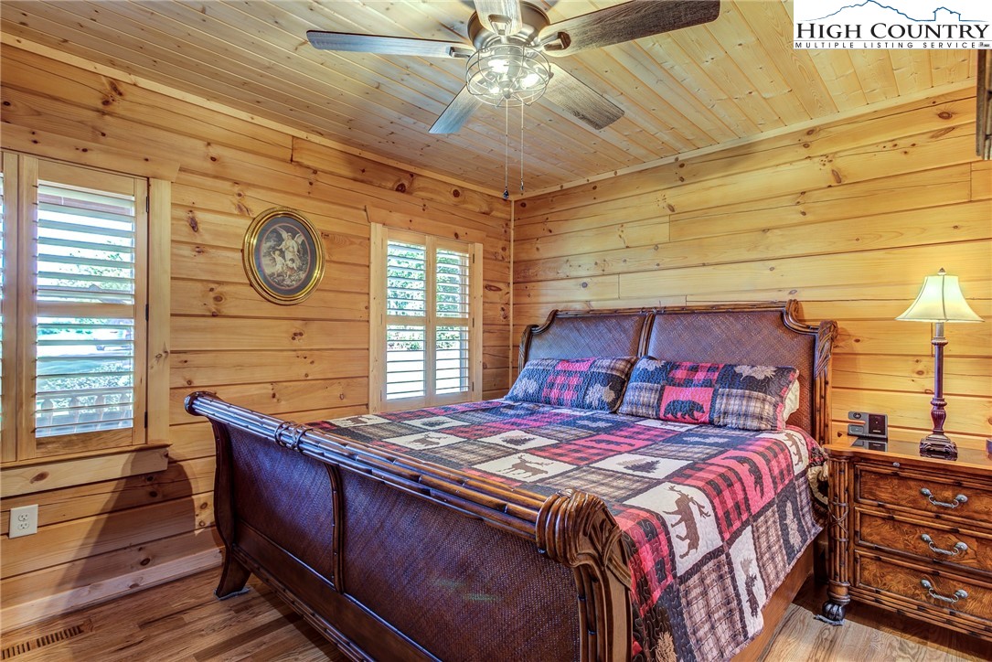 3460 South Center Church Road Thurmond, NC 28683 - Photo 26 of 50 a bedroom with a bed and a chandelier
