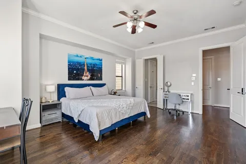 a spacious bedroom with a bed and a chandelier