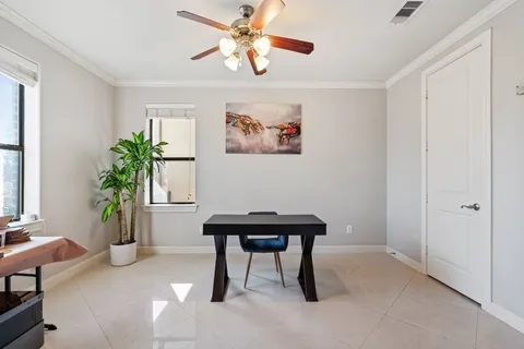 a view of a workspace with furniture and a potted plant