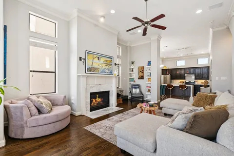 a living room with furniture kitchen view and a fireplace