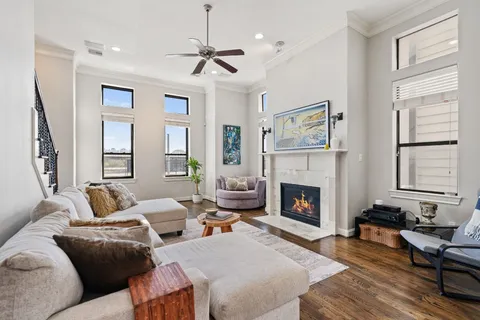a living room with furniture large window and fireplace