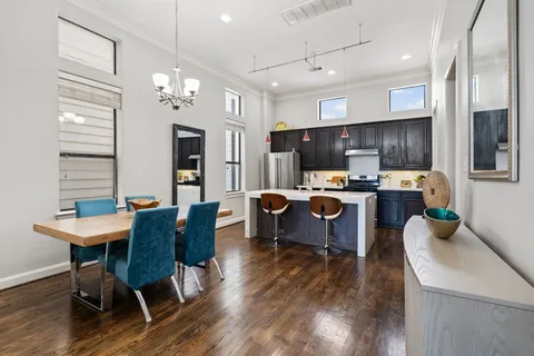 a living room with furniture a dining table and kitchen view