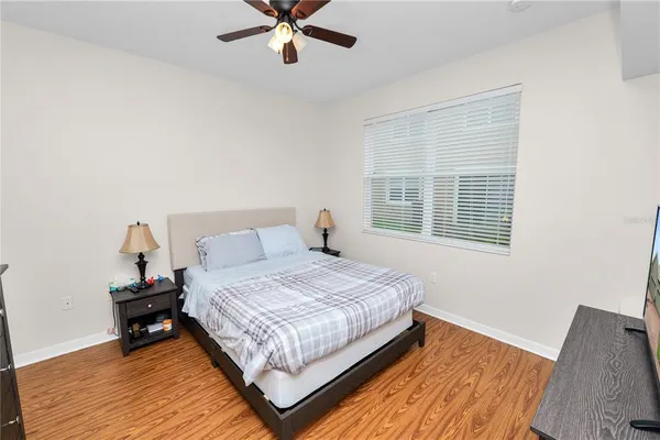 a bedroom with a bed and a window