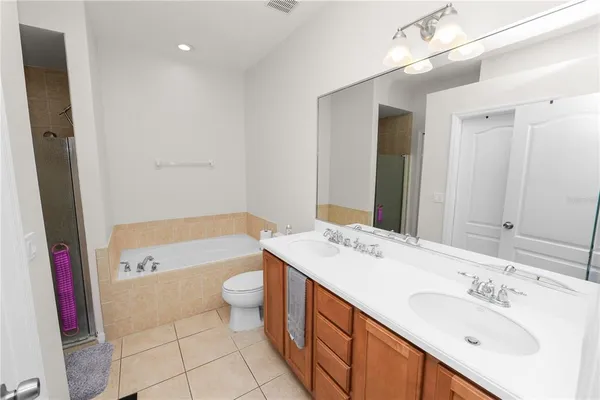 a bathroom with a sink a toilet a mirror and shower