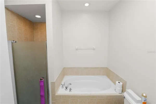 a bathroom with a tub and shower