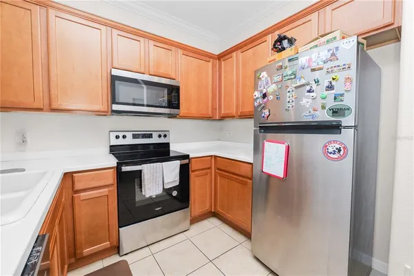 a kitchen with stainless steel appliances granite countertop a refrigerator and a stove top oven