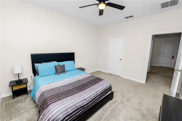 a bedroom with a bed and a chandelier
