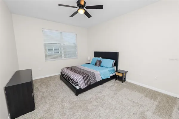 a bedroom with a bed and window