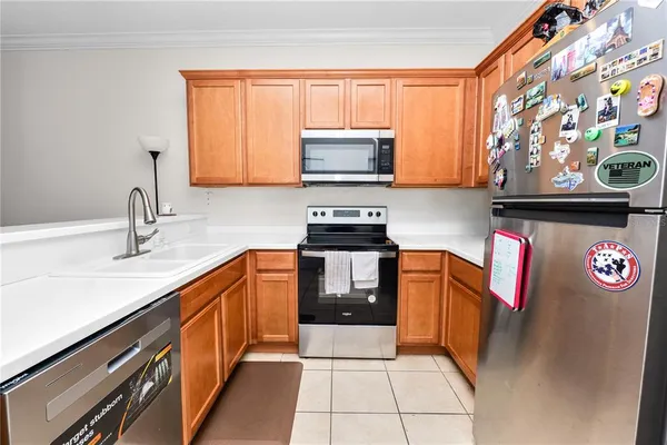 a kitchen with stainless steel appliances granite countertop a sink stove and microwave