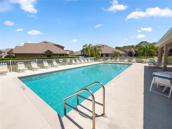 a view of swimming pool with a table and chairs