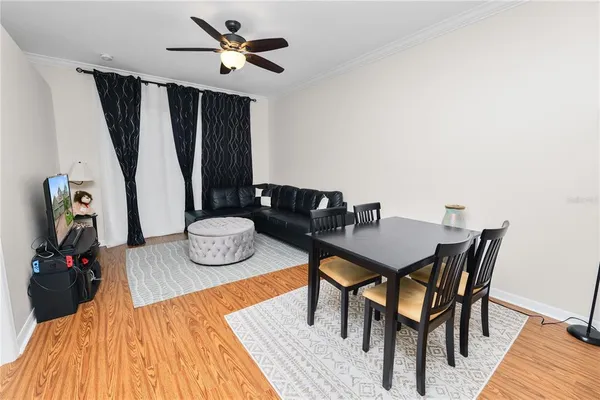 a view of a dining room with furniture and wooden floor