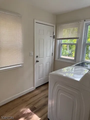 a bed sitting in a spacious bedroom next to a window
