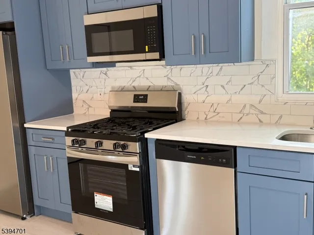 a kitchen with granite countertop cabinets and a stove top oven