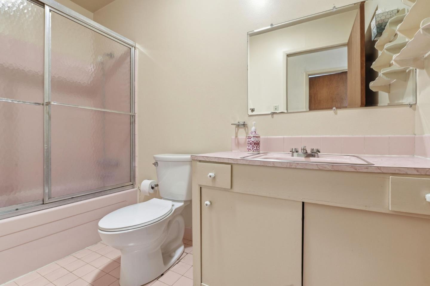 3915 Kingridge Drive San Mateo, CA 94403 - Photo 32 of 47 a bathroom with a toilet a sink a mirror and shower