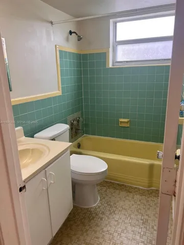 a bathroom with a sink a toilet and bathtub
