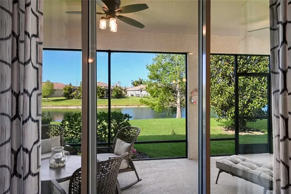 a balcony view with a large window and sitting area