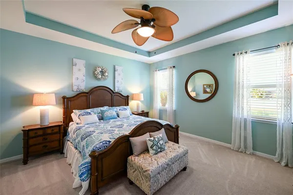 a bedroom with a bed and a chandelier