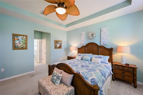 a bedroom with a bed and ceiling fan