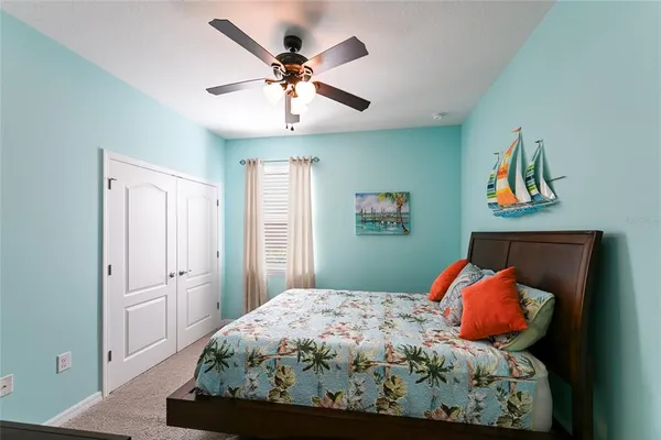 a bedroom with a bed and painting on the wall