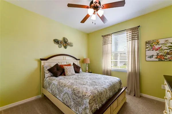 a bed sitting in a bedroom next to a window