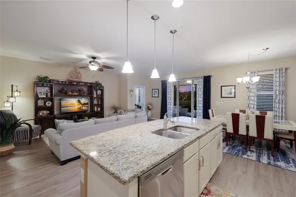a large kitchen with sink a counter space and living room