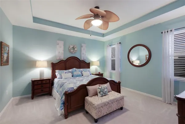 a bedroom with bed and a chandelier