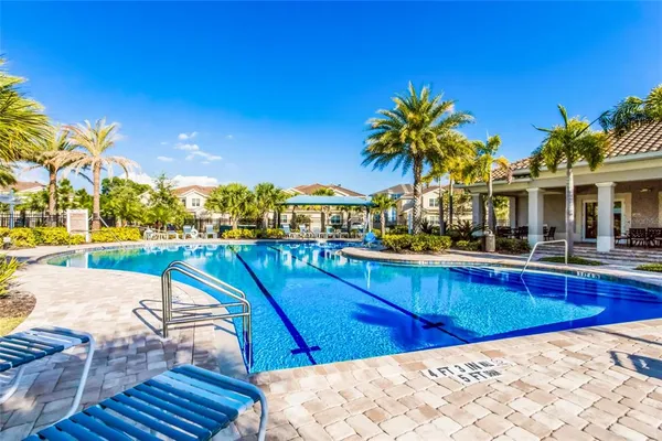 a swimming pool with outdoor seating and yard