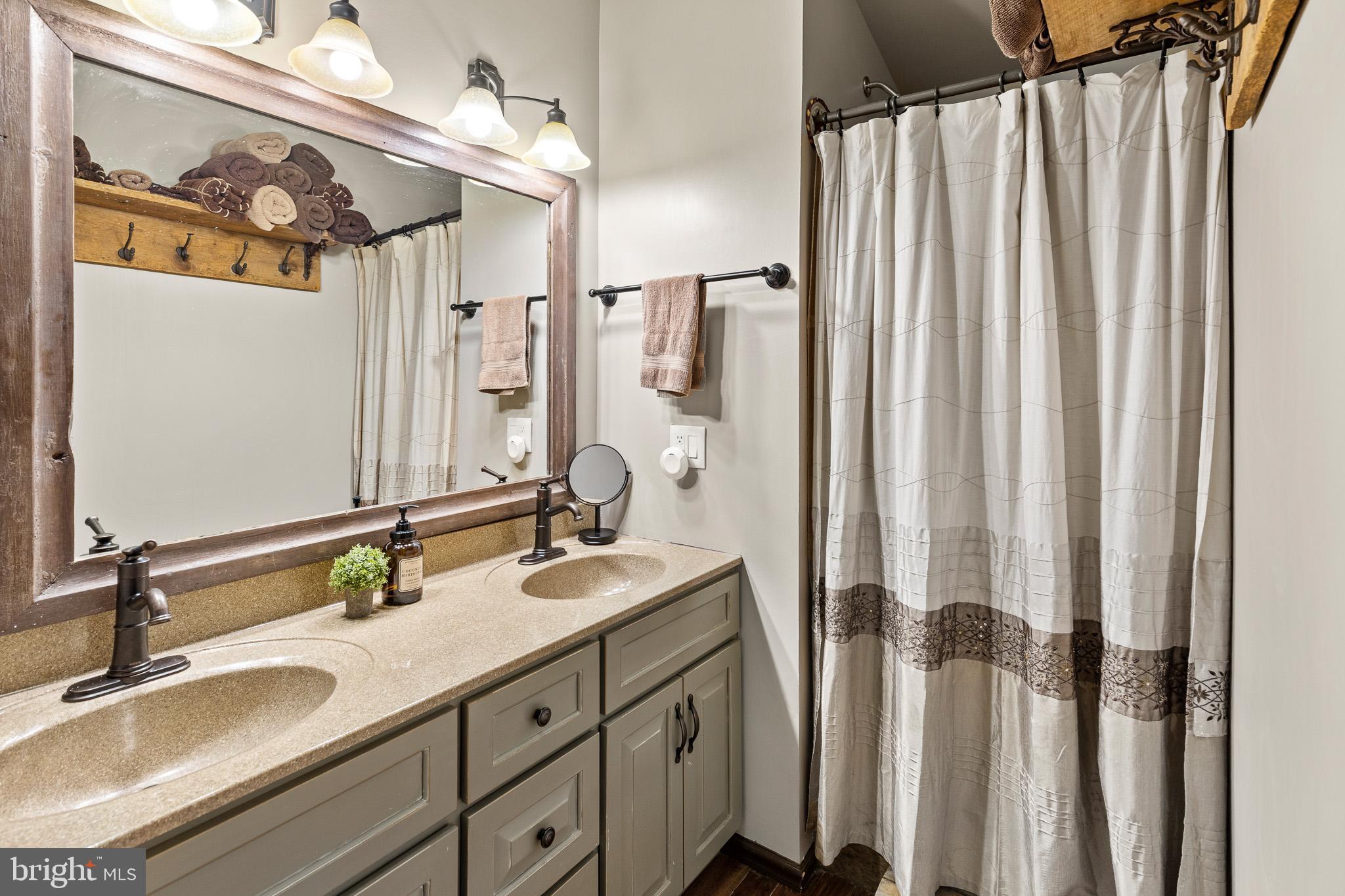 491 Sheep Hill Road Newmanstown, PA 17073 - Photo 21 of 30 a bathroom with a double vanity sink and a mirror