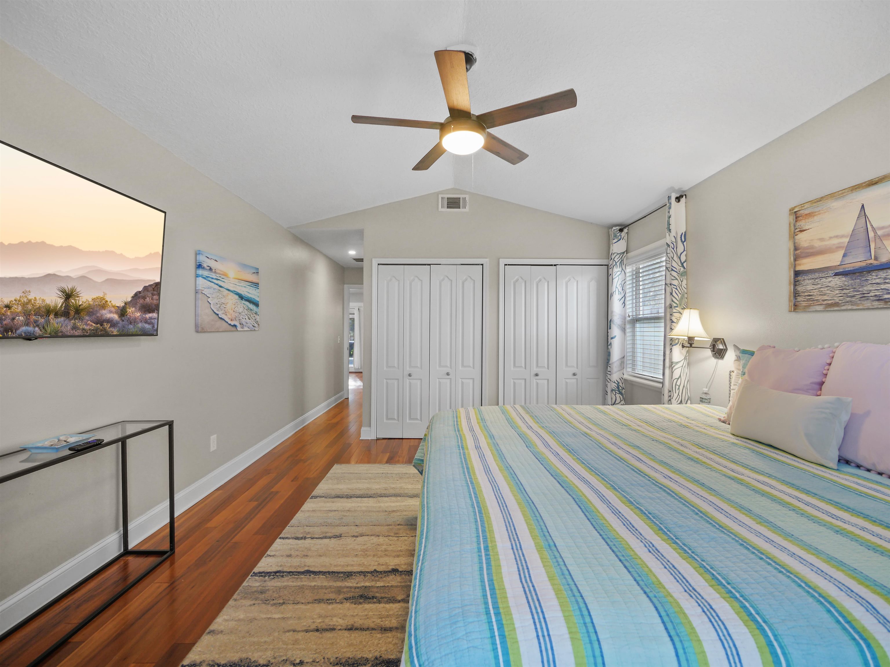 5301 1st Street St. Augustine, FL 32080 - Photo 16 of 36 a bedroom with a bed and a chandelier