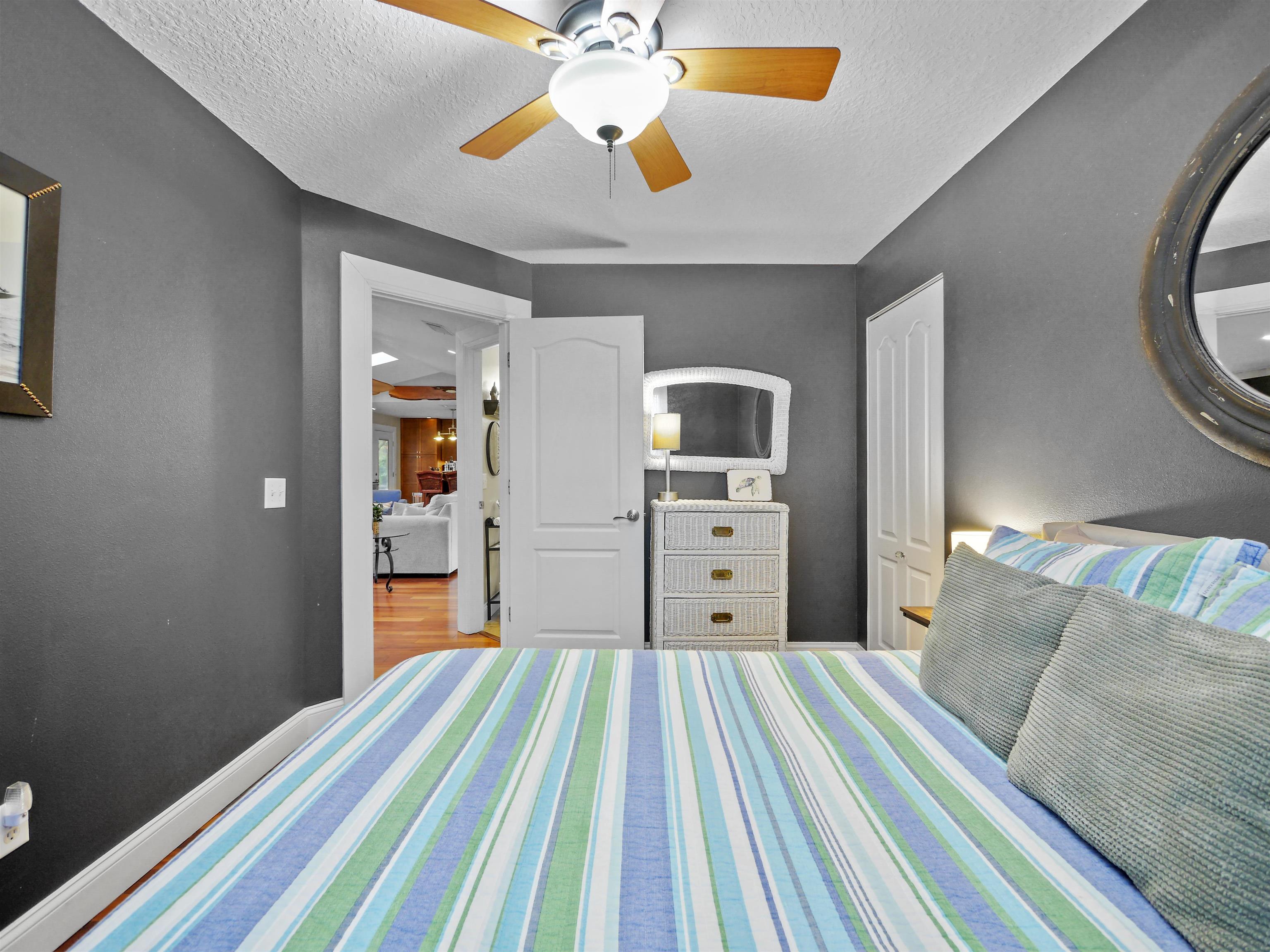 5301 1st Street St. Augustine, FL 32080 - Photo 20 of 36 a bedroom with a bed and a chandelier