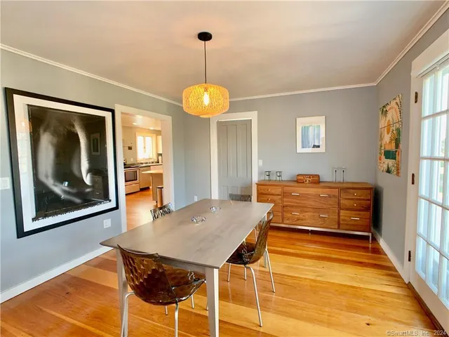 a view of a dining room with furniture and window