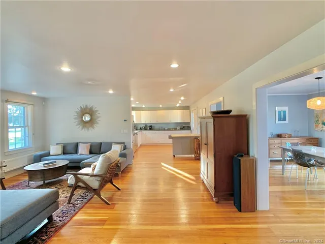 a living room with dining room and wooden floor
