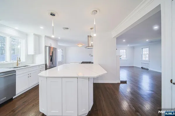 a large kitchen with stainless steel appliances kitchen island a large island in the center