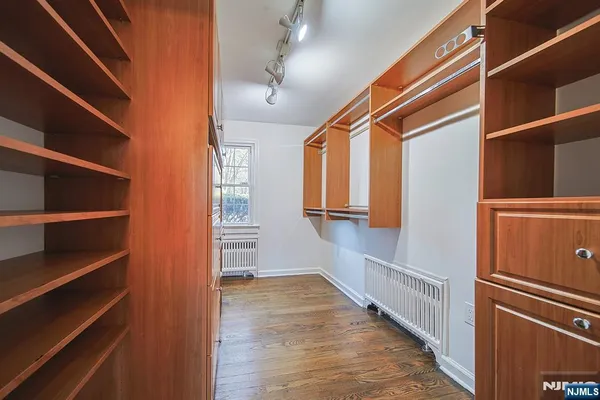 a view of walk in closet with empty racks