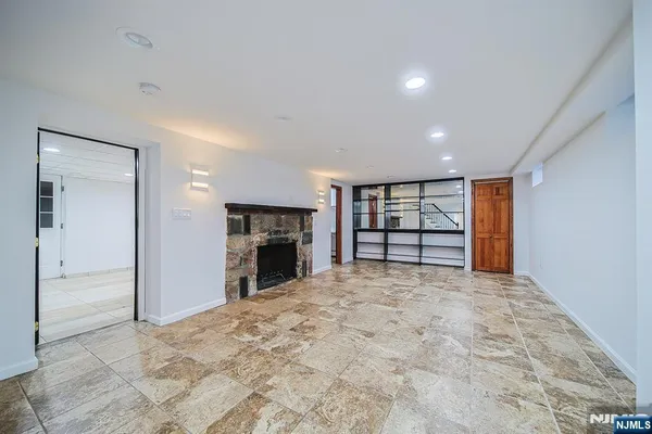 a view of empty room with a fireplace