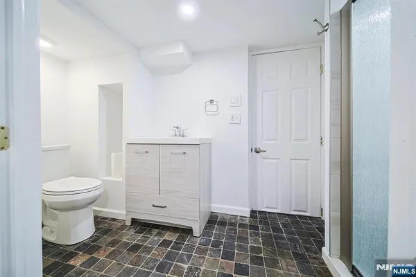 a bathroom with a toilet and a shower