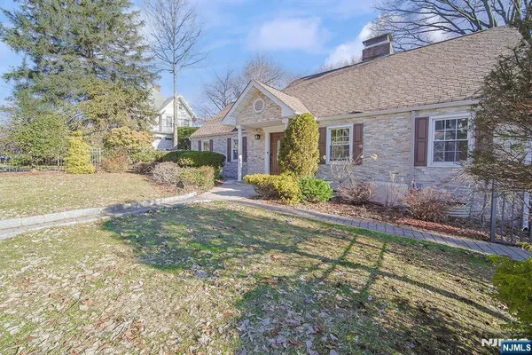 a view of the house with snow on the road
