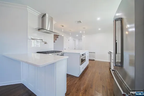 a kitchen with a sink a counter top space stainless steel appliances and a window