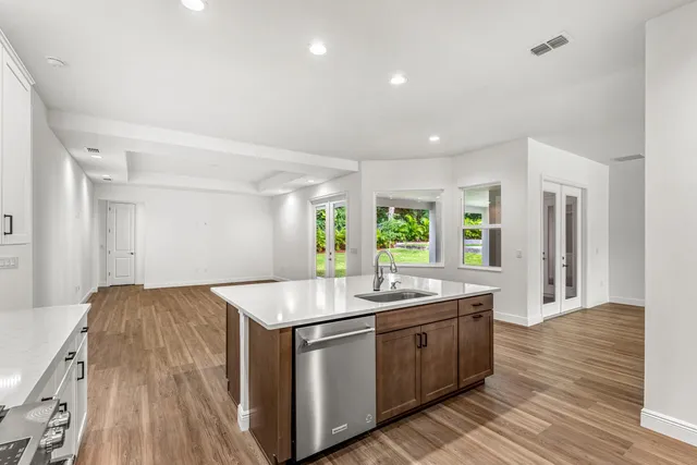 a kitchen with sink stove and refrigerator
