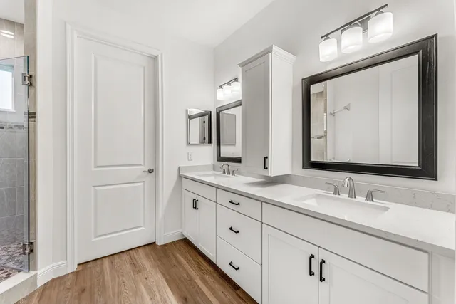a bathroom with a double vanity sink and a mirror