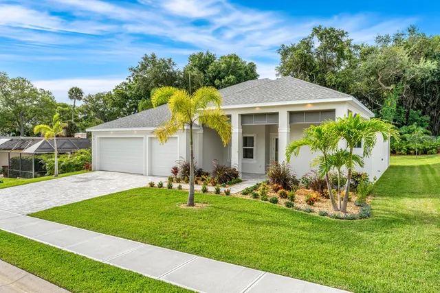 a front view of house with yard and outdoor seating