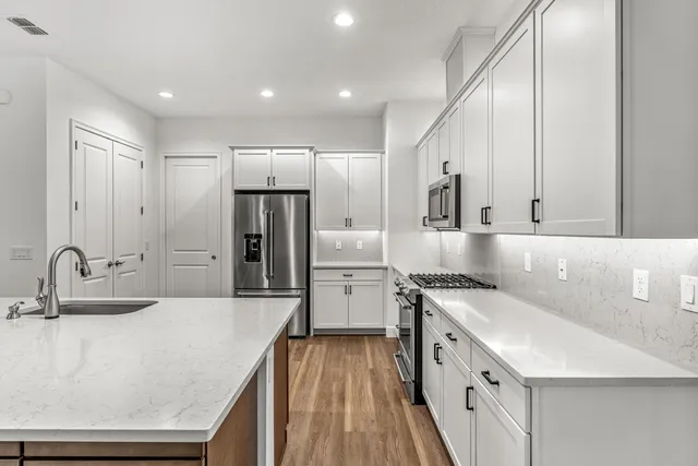 a kitchen with a sink a refrigerator and a stove