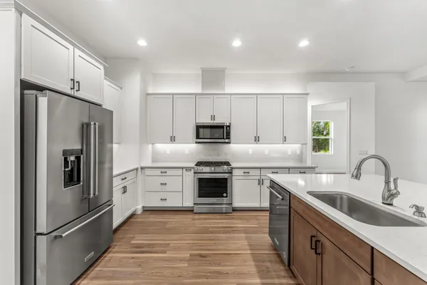 a kitchen with a sink stove and refrigerator
