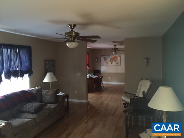 4248 Roundabout Road Louisa, VA 23093 - Photo 5 of 9 a living room with furniture and a lamp